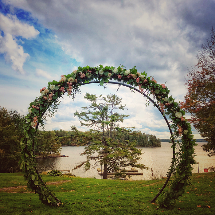 Floral wedding arbour overlooking Lake Rosseau at Windermere House